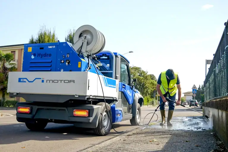 EVI Country Electric 4x4 with street-cleaning equipment in an urban setting
